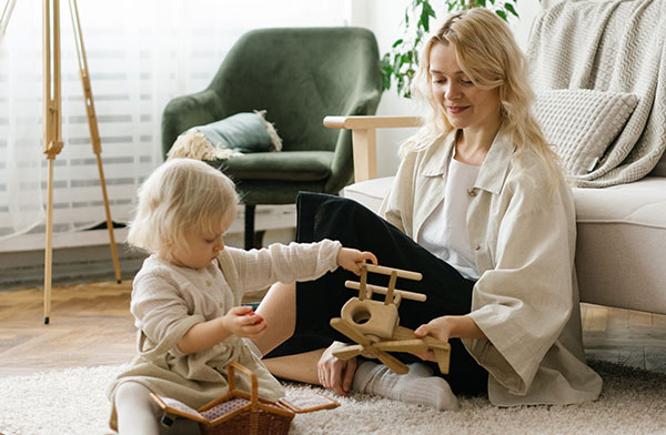 This image shows a woman and a baby sitting on a newly serviced carpet.