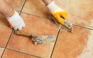 This image shows a man repairing floor tiles.