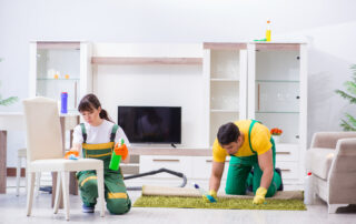 This image shows a man and a woman cleaning a chair and a carpet.